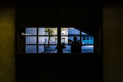 Reflection of silhouette people on glass window