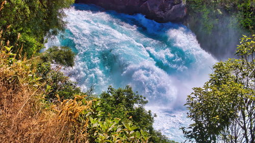 Scenic view of waterfall against sky