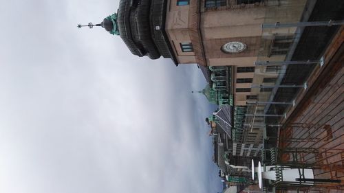 Low angle view of church against cloudy sky