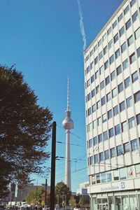 Low angle view of modern building against blue sky