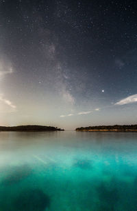 Scenic view of lake against sky at night