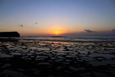 Scenic view of sea against clear sky during sunset