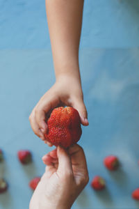 Close-up of hand holding strawberries