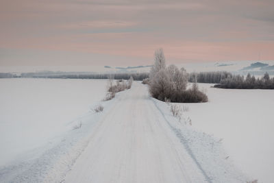 Snow covered landscape against sky