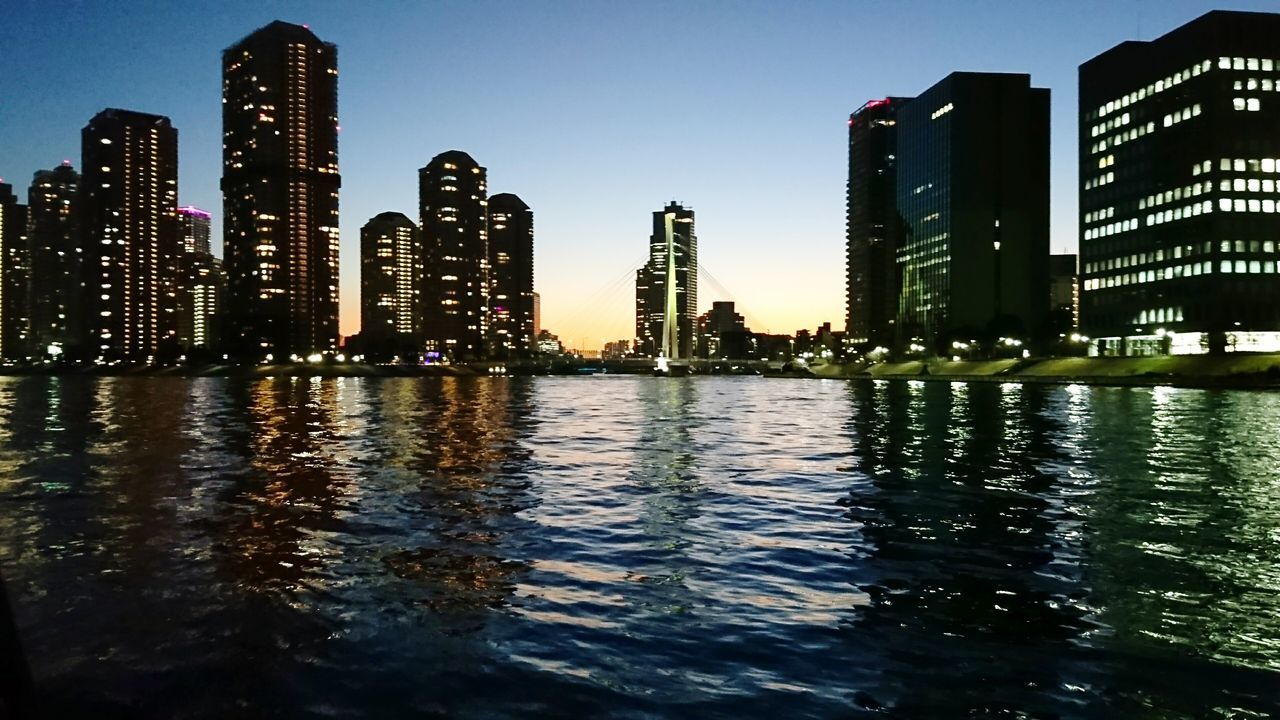 VIEW OF SKYSCRAPERS AT NIGHT