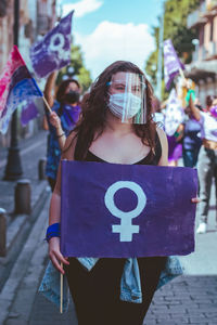 Woman standing on street in city