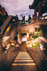 Staircase leading towards temple against sky