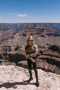 Full length portrait of man standing on rock