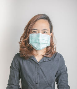 Portrait of mid adult woman against white background