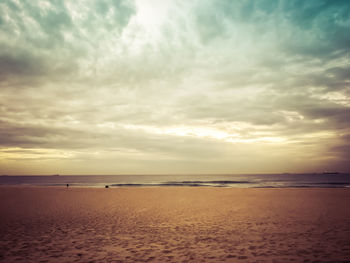 Scenic view of beach against sky during sunset