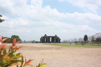 Historic building on field against sky