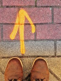 Low section of person standing on zebra crossing