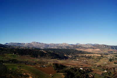 Scenic view of mountains against clear blue sky