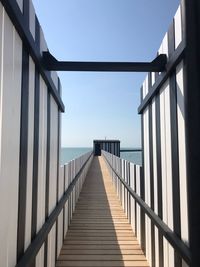 View of pier on sea against clear sky