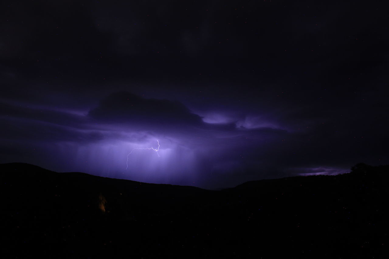 night, beauty in nature, sky, lightning, power in nature, cloud, darkness, storm, thunderstorm, scenics - nature, environment, mountain, dramatic sky, nature, no people, star, thunder, dark, landscape, silhouette, awe, warning sign, storm cloud, outdoors, astronomy, space, illuminated, atmospheric mood