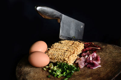 Close-up of breakfast on table against black background