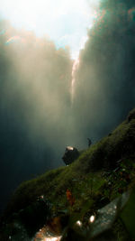 Scenic view of waterfall against sky