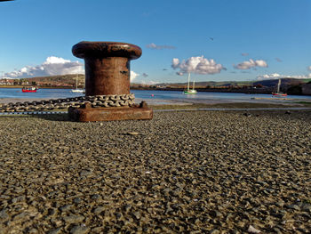 Lighthouse by sea against sky