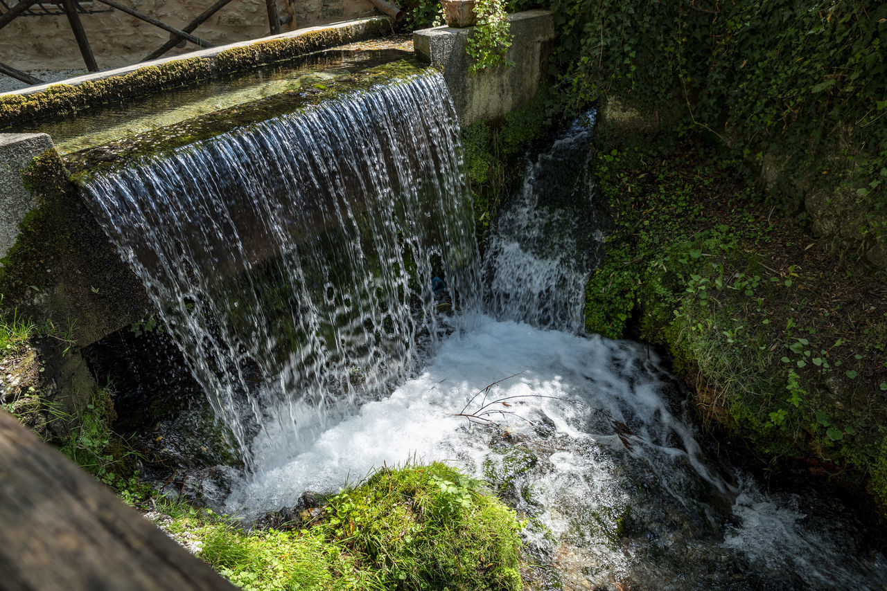 water, waterfall, motion, flowing water, nature, beauty in nature, watercourse, body of water, plant, long exposure, scenics - nature, no people, splashing, tree, stream, flowing, blurred motion, day, water feature, outdoors, rock, environment, forest, land, river, growth, sports