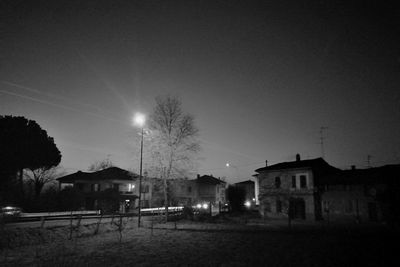 Illuminated buildings against sky at night