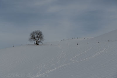 Scenic view of snow covered landscape against sky