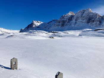 Scenic view of snowcapped mountains against clear blue sky