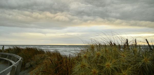 Scenic view of sea against cloudy sky