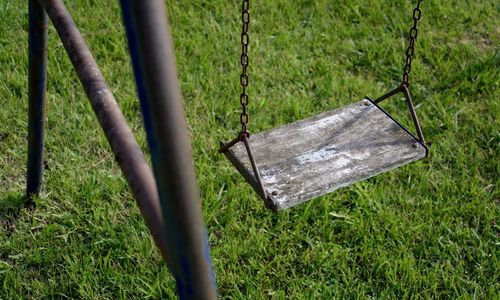 High angle view of swing over grassy field at playground