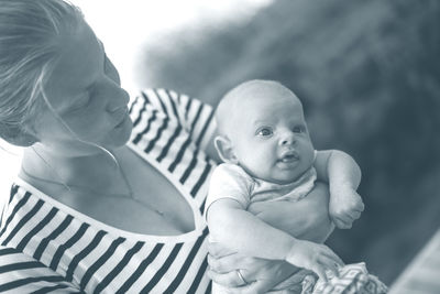 Mother embracing cute baby boy