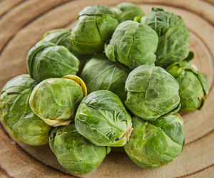 Brussels sprouts stacked in pile on wooden background