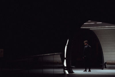 Man standing by staircase