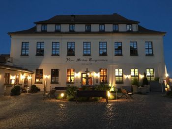 Illuminated building against sky at night