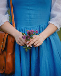 Midsection of woman holding bouquet