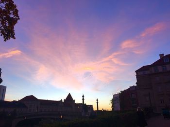 Silhouette city against sky during sunset