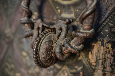Close-up of doorknob on old metallic door
