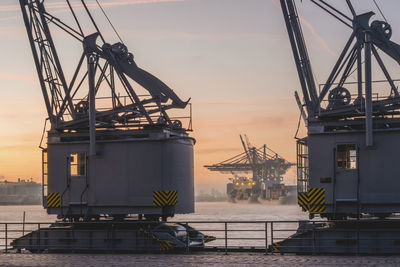 Germany, hamburg, harbor cranes at dawn