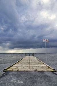 Pier over sea against sky