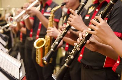 Midsection of people playing flute