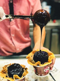 Close-up of hand holding ice cream