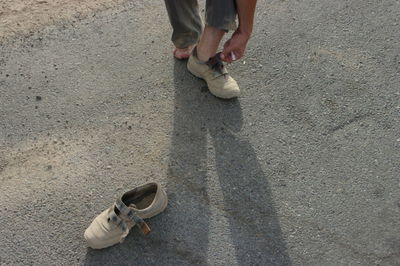 Low section of woman walking on road