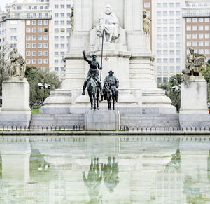 Reflection of statue in pond