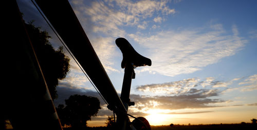 Low angle view of silhouette bicycle against sky during sunset