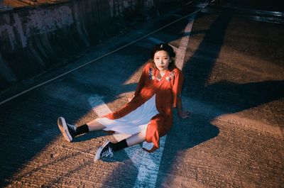 High angle portrait of woman sitting on floor