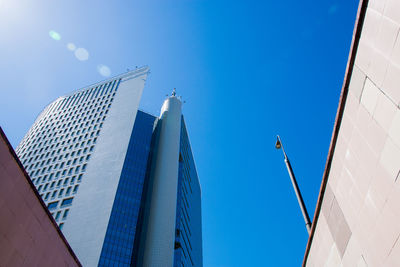 Low angle view of modern buildings against clear blue sky