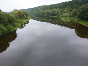 Reflection of trees in lake against sky