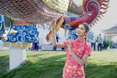 Happy chinese new year. asian woman wearing traditional cheongsam qipao dress.