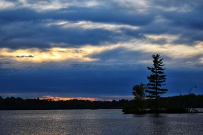 Scenic view of lake against sky at sunset