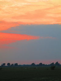 Scenic view of field against sky during sunset