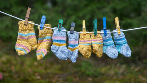 Photography with knitted socks, socks hanging on a rope, handicraft concept, knitting as a hobby