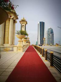 Narrow pathway leading towards temple against clear sky